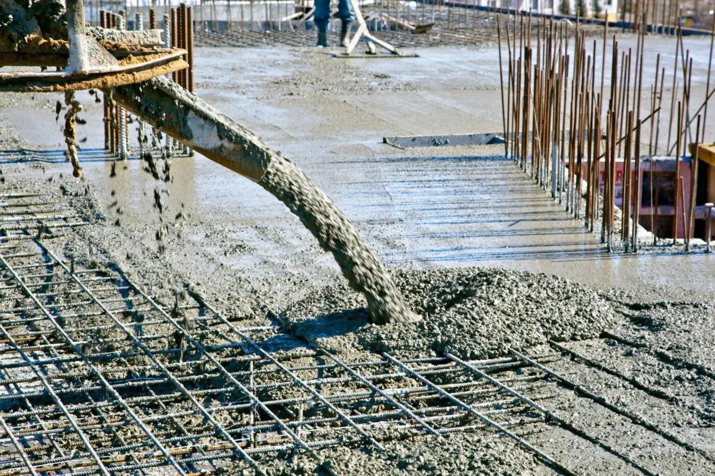 with the use of a specialized machine, the local contractor in Miami FL is pouring concrete mix into the frame