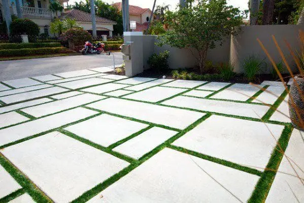 artificial grass installed between paved concrete driveway in Miami FL