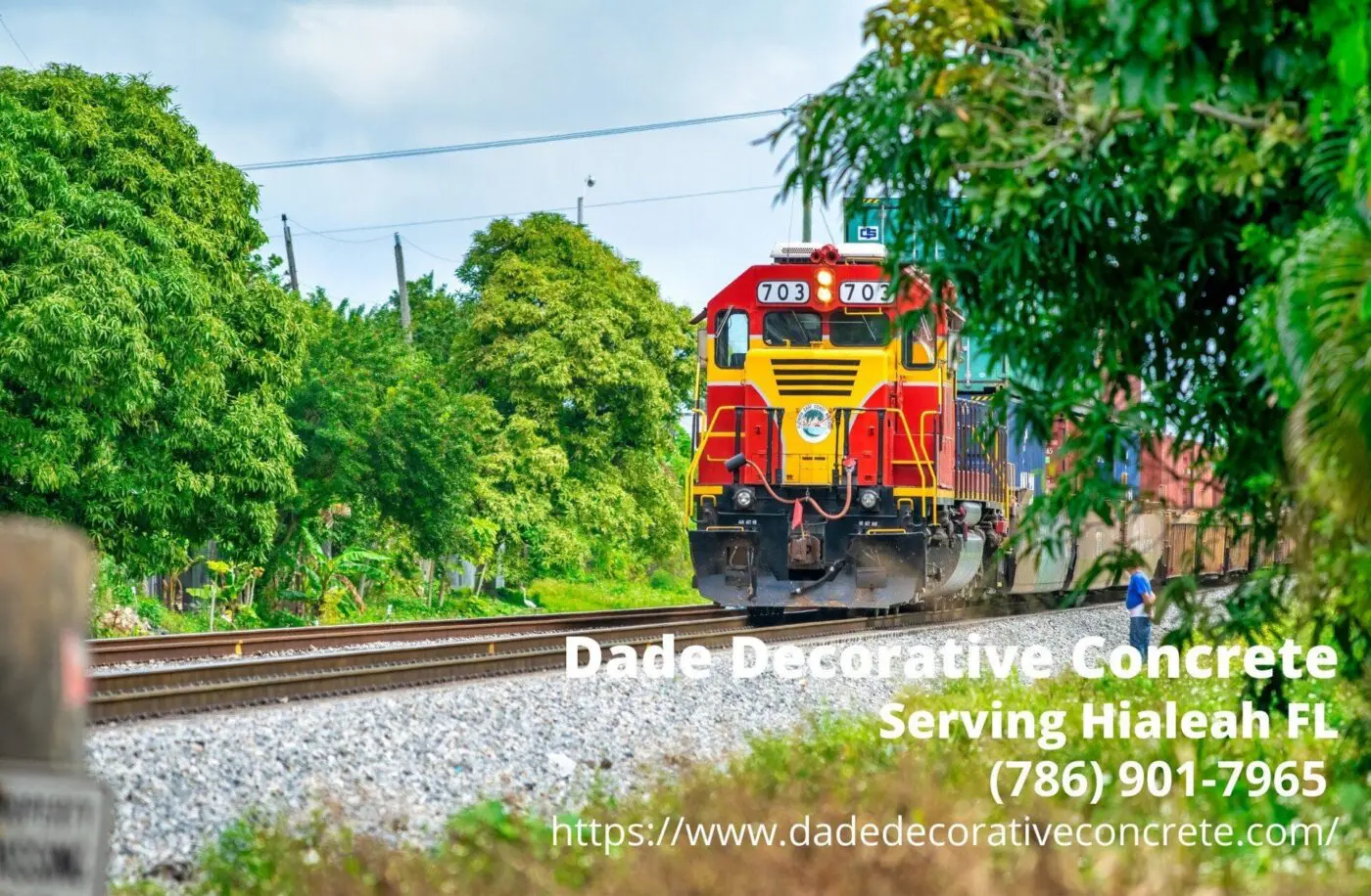 red and yellow train speeding up featuring the business info of Dade Decorative Concrete